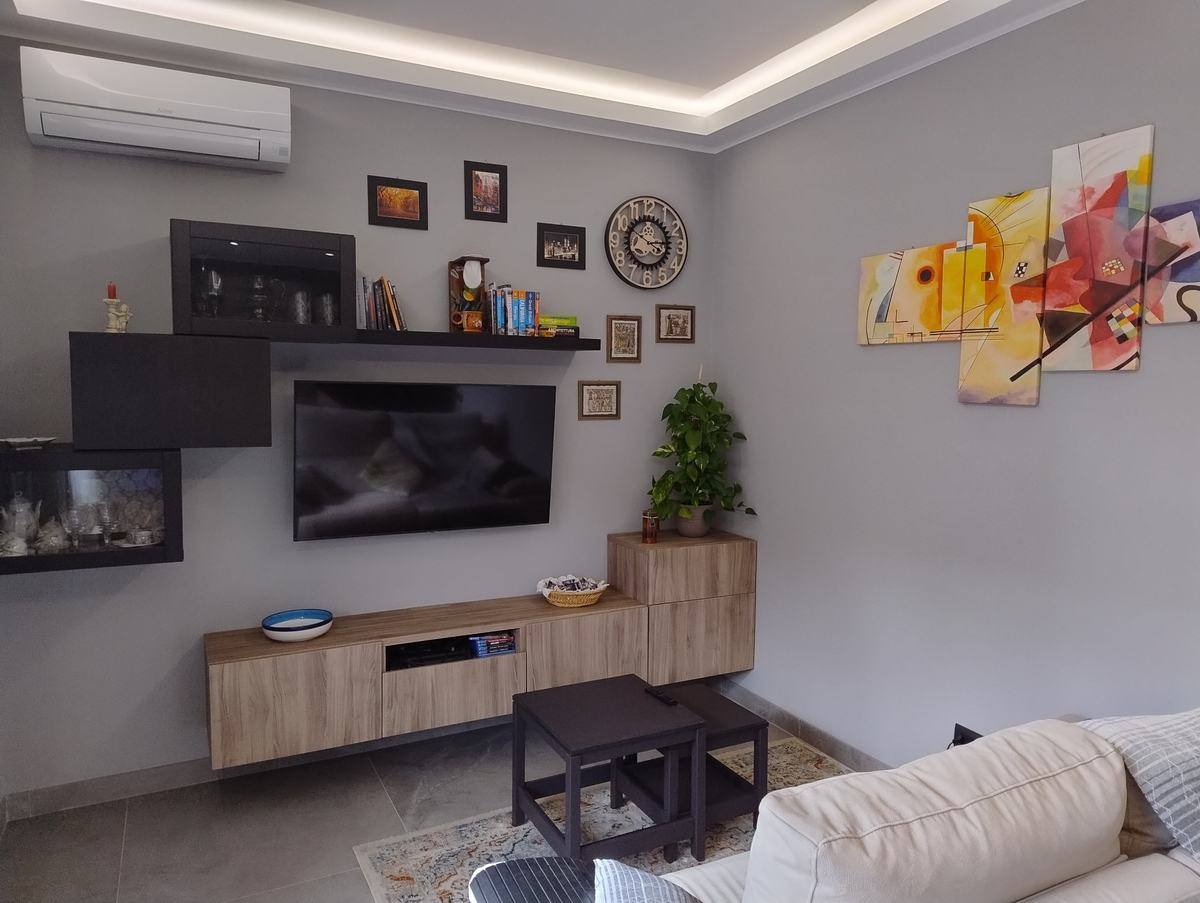 Living room with 50-inch Smart TV and air conditioning